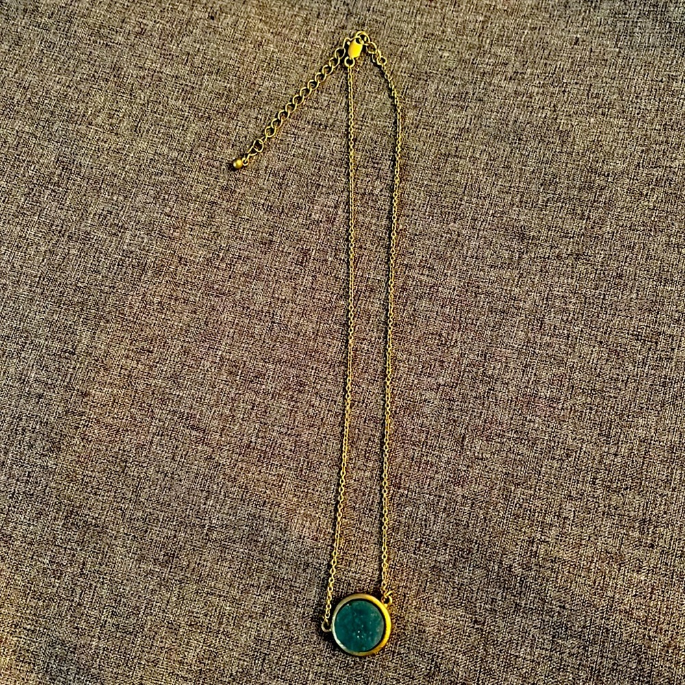 Gold necklace with sparkly blue stone